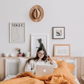 woman using laptop in bed